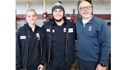 Winners of the Golden Tire Iron competition, Nina and Matt, stand with their regional director, Scott Clayton, after changing a set of four tires in eight minutes and 48 seconds.
