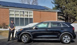 Craig Van Batenburg is pictured next to a Kia Niro EV, one piece of the electric and hybrid fleet at his training business, Automotive Career Development Center (ACDC.)