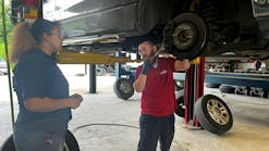 Manager Russ Disalvo talks through a brake service job with Anastasia Dukes, a general service technician at Chabill's Tire & Auto Service. The tire dealership has noticed a trend that its young managers experience less turnover among their youngest staff members.