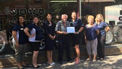 Ted Mahone (center), owner of Mahone Tire in Marietta, Ohio, credits the longevity to a service-oriented approach and involvement in his community.